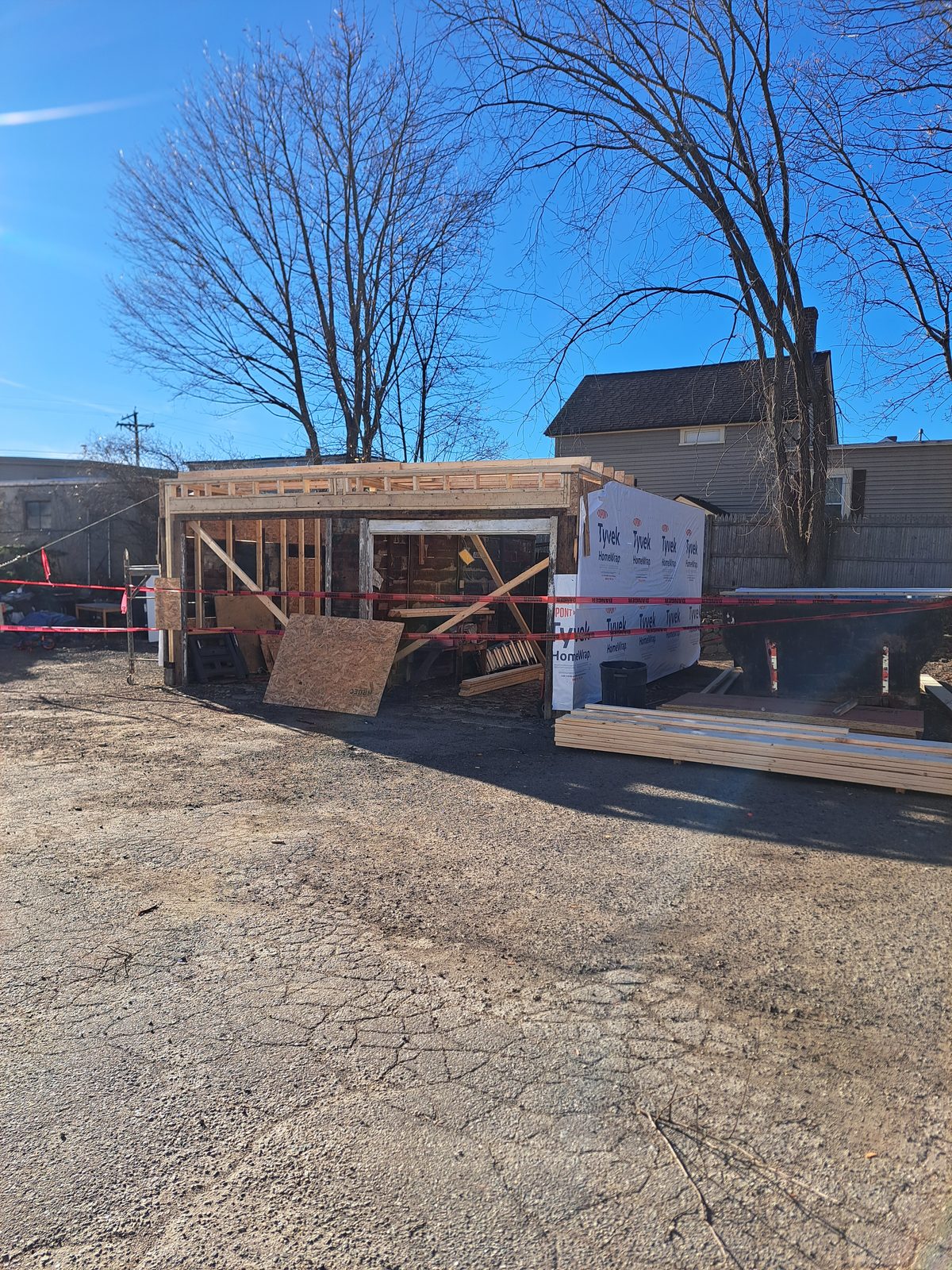 Before — garage addition framing with house wrap in Sutton, MA Before — garage addition framing with house wrap in Sutton, MA