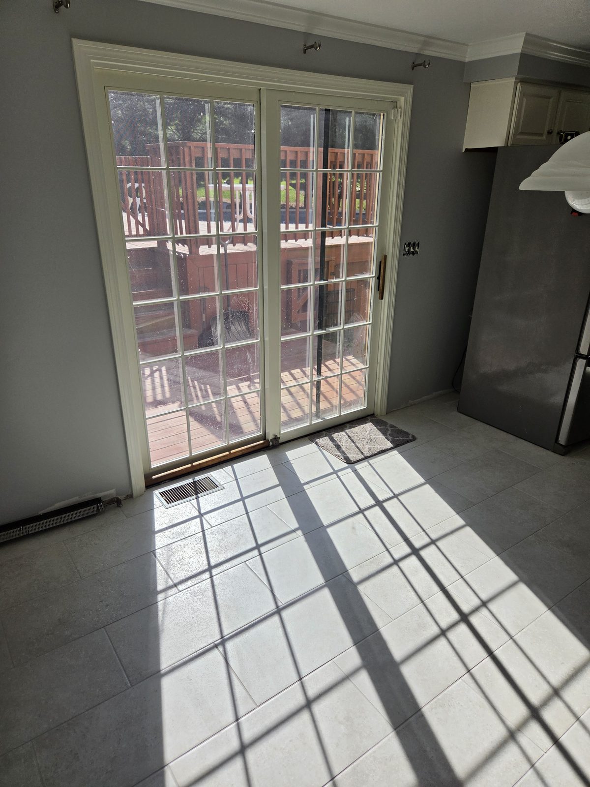 After — French patio doors and tile flooring in a Sutton, MA kitchen After — French patio doors and tile flooring in a Sutton, MA kitchen