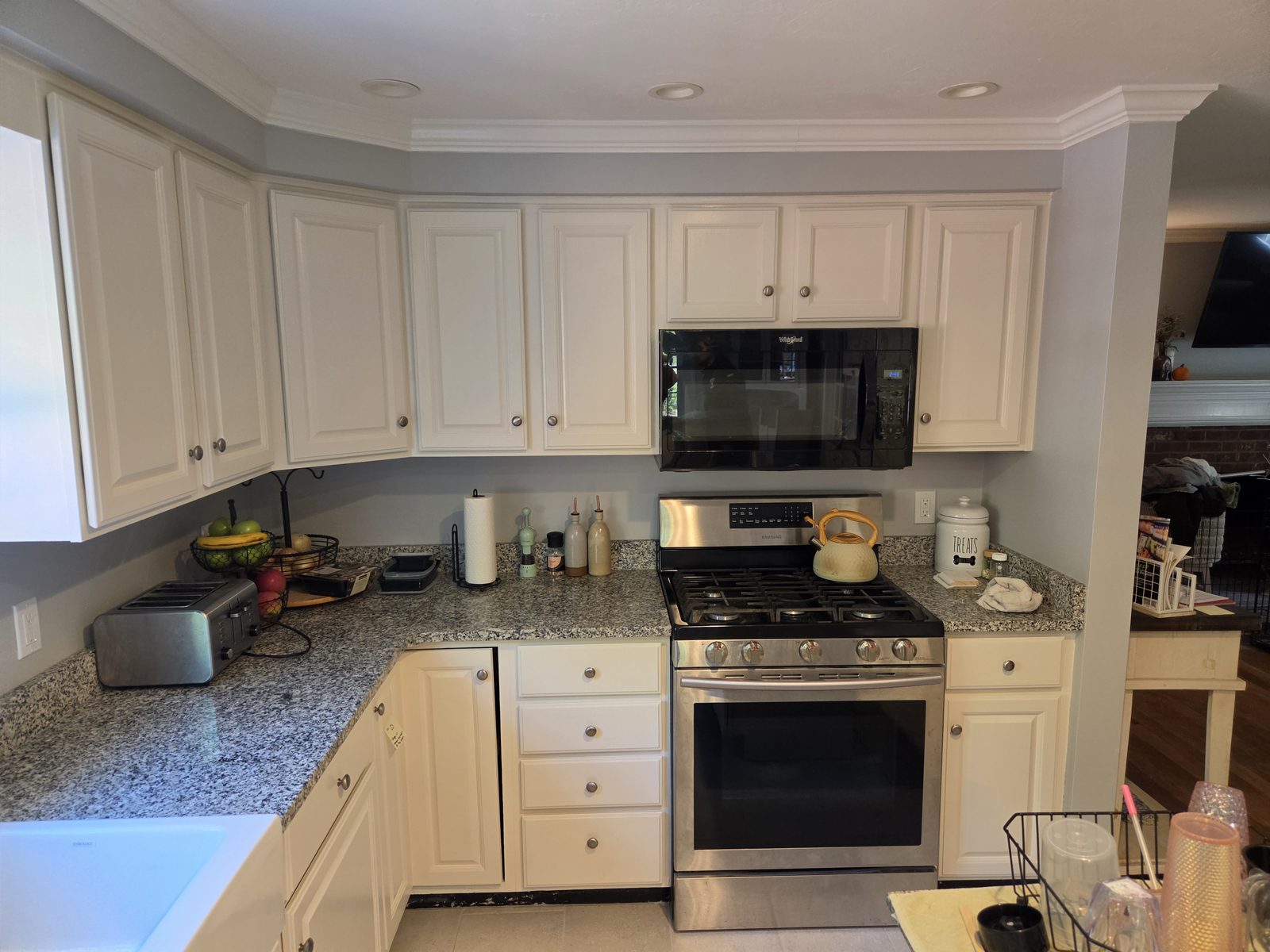 After — range, microwave, and white upper cabinets in a Sutton, MA kitchen After — range, microwave, and white upper cabinets in a Sutton, MA kitchen