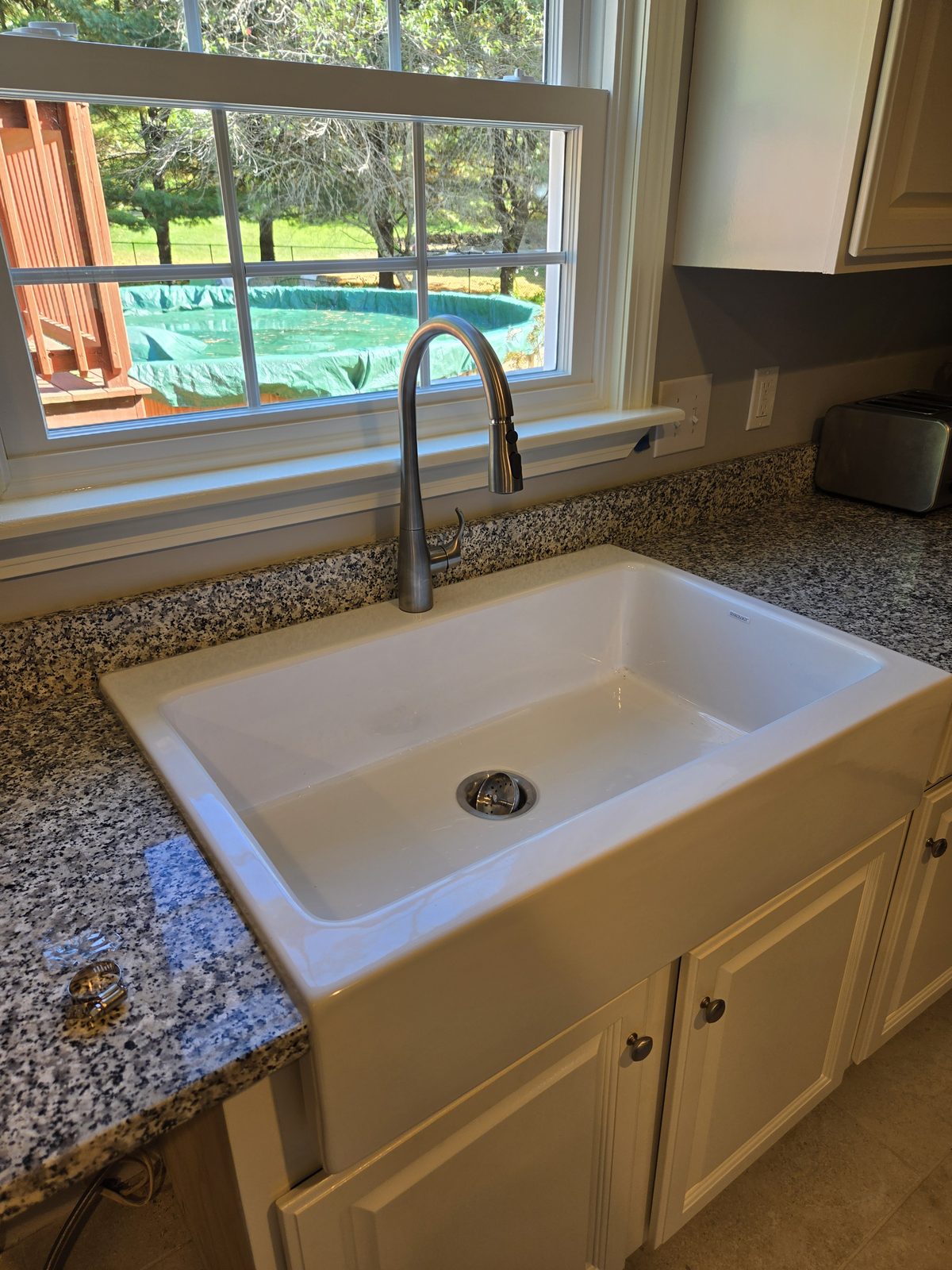 After — farmhouse sink and faucet under a kitchen window in Sutton, MA After — farmhouse sink and faucet under a kitchen window in Sutton, MA