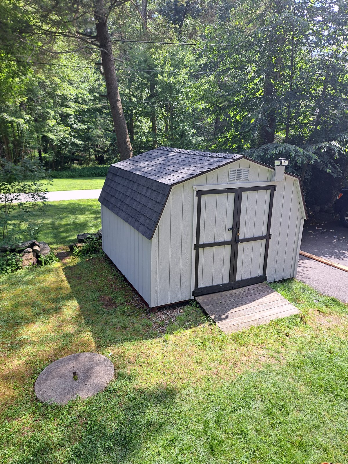 After — completed gray shed siding and roofing in Sutton, MA After — completed gray shed siding and roofing in Sutton, MA