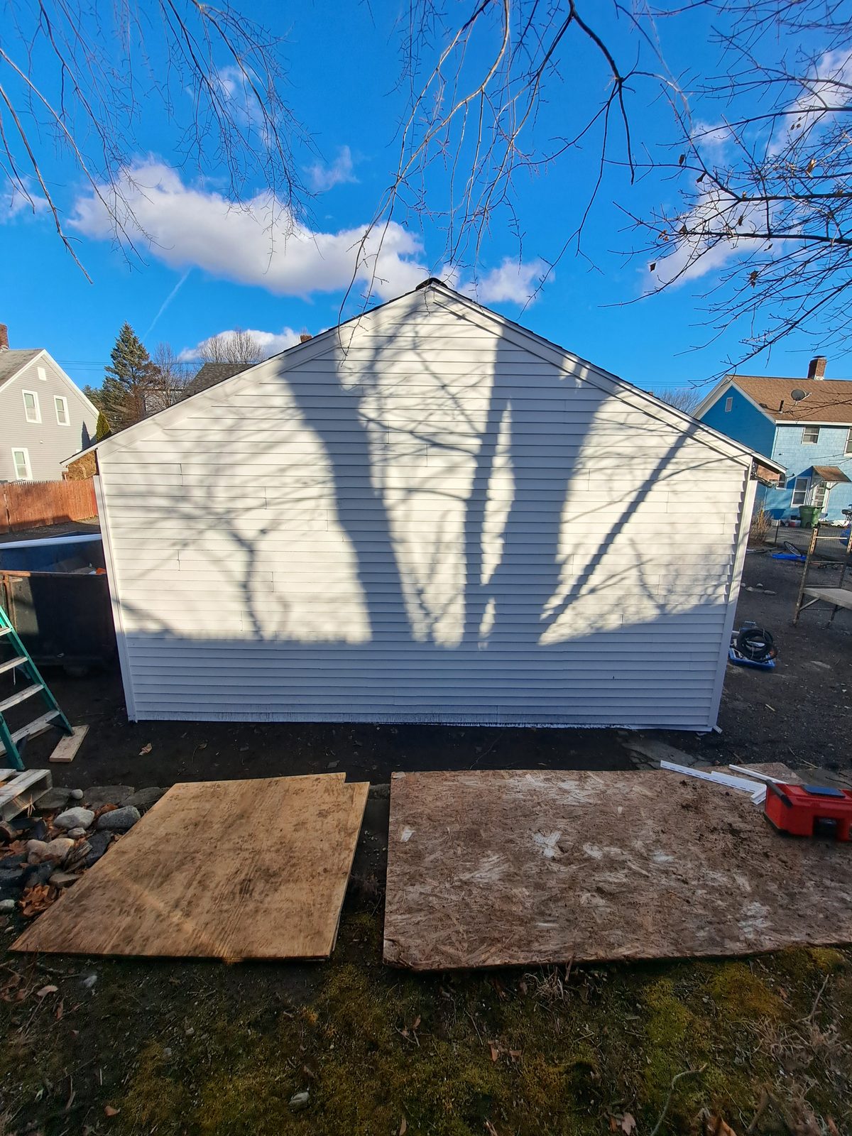 After — completed white vinyl siding on a garage gable in Sutton, MA After — completed white vinyl siding on a garage gable in Sutton, MA
