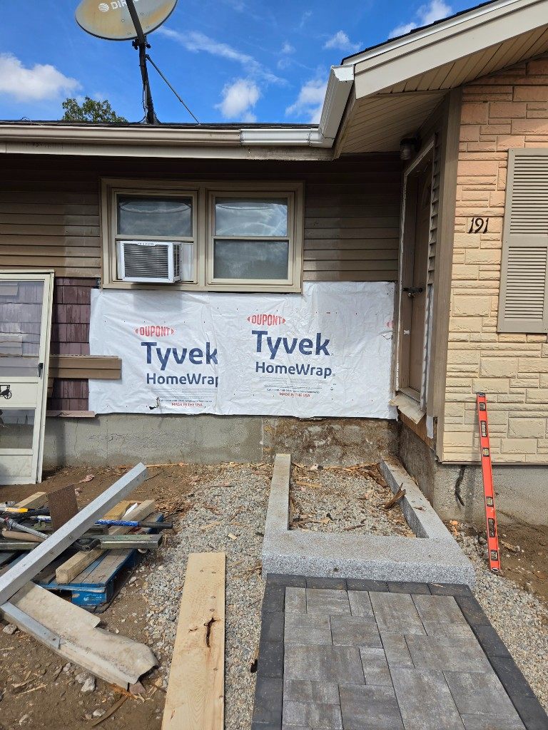 Before — house wrap on an entry wall during siding repair in Sutton, MA Before — house wrap on an entry wall during siding repair in Sutton, MA